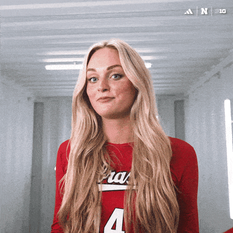 a woman in a red shirt with the number 4 on the front