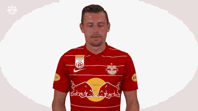 a man wearing a red and white jersey with a bull on it