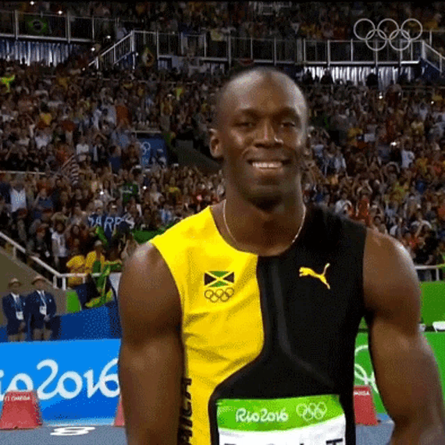 a man wearing a yellow and black shirt with the word jamaica on it