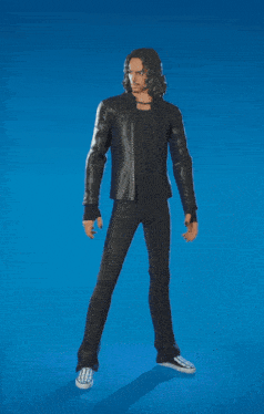 a man wearing a black leather jacket and black pants is standing in front of a blue background