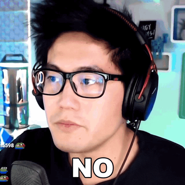 a man wearing glasses and headphones with the word no on his face
