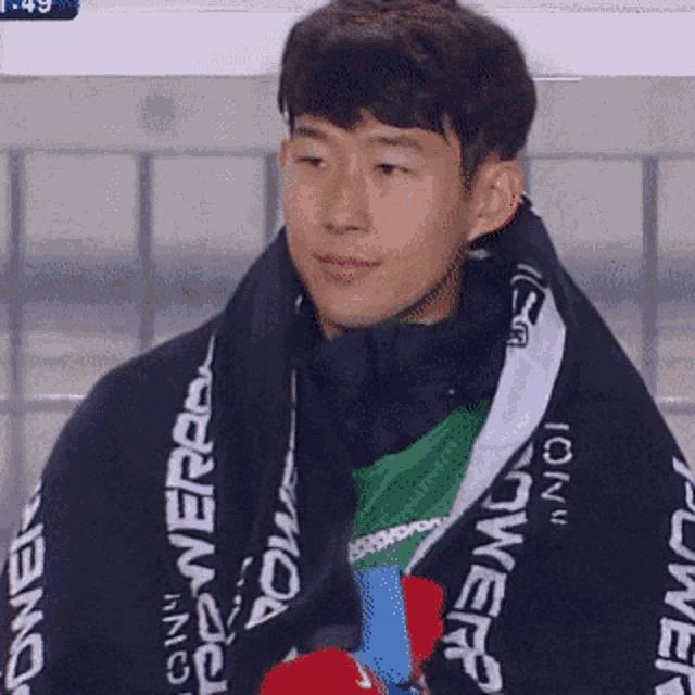 a man wearing a black scarf with the word power on it