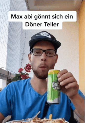a man holding a can of osb soda