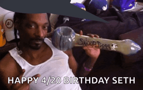 a man in a white tank top is holding a pipe that says snoop dogg