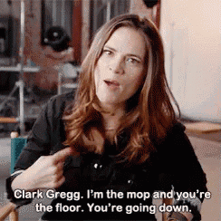 a woman is talking to clark gregg who is pointing at her