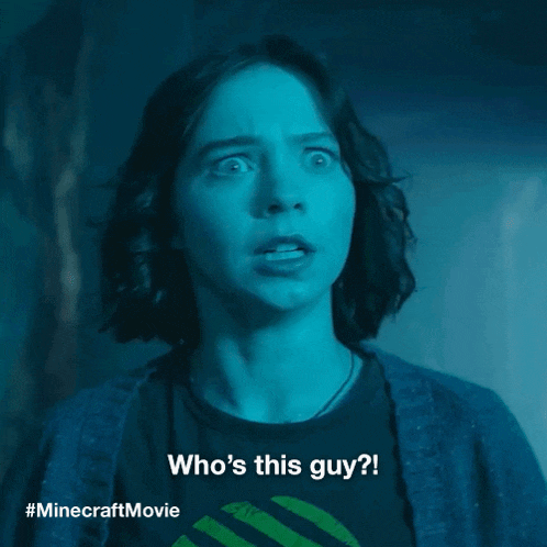 a woman with a surprised look on her face is wearing a minecraft movie shirt