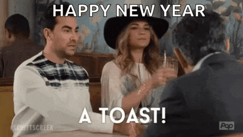 a man and a woman are sitting at a table in a diner talking to each other and toasting .