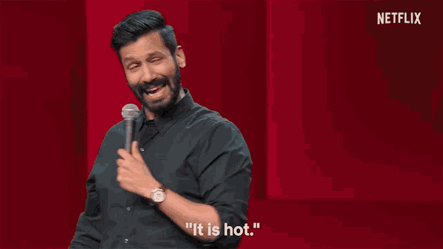 a man stands in front of a microphone and says it is hot