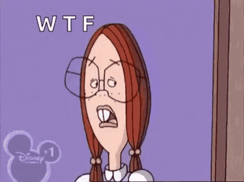 a cartoon girl is sitting at a desk in front of a computer with the words wtf written on the bottom
