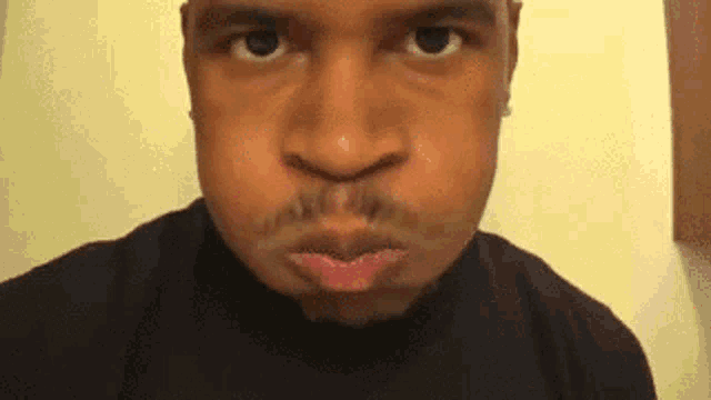 a close up of a man 's face with his mouth open