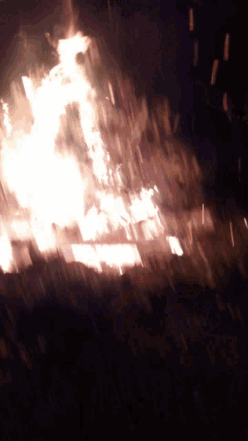 a large fire is burning in a dark room at night