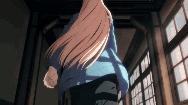 a woman with long blonde hair is walking through a hallway