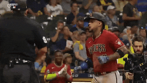 a baseball player for the arizona a's is talking to an umpire