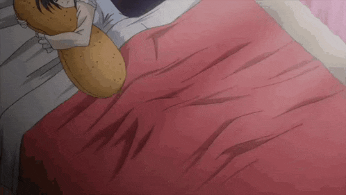 a person is laying on a bed with a pillow on their chest .