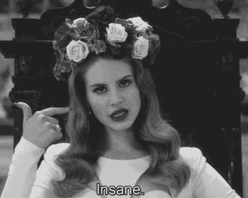 a black and white photo of a woman with a flower crown on her head and the words insane below her
