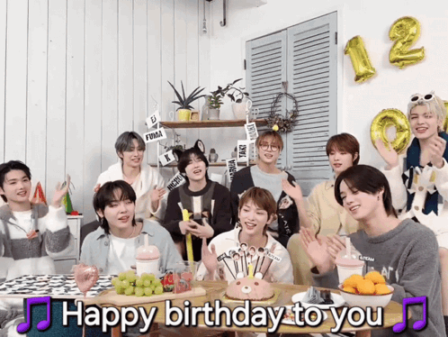 a group of young men are gathered around a table with a birthday cake and the words happy birthday to you