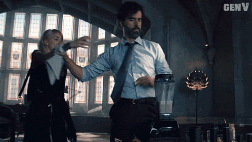 a man and a woman are dancing in front of a blender with the word genv on the bottom