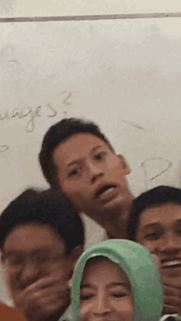 a group of people covering their mouths in front of a whiteboard that says ' ways ' on it
