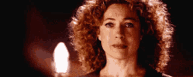 a close up of a woman 's face with curly hair