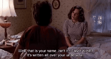 a man and a woman are sitting on a bed and the woman says well that is your name isn't it calvin klein