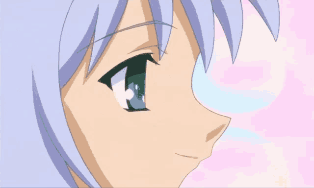 a close up of a girl 's face with blue hair