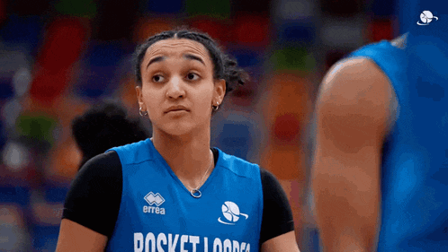 a female basketball player wears a blue jersey that says pocket lodge