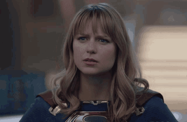 a close up of a woman 's face in a superman costume