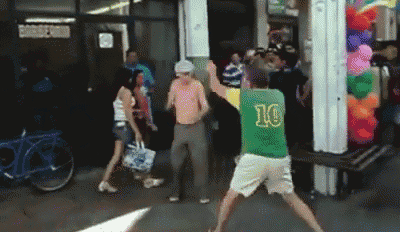 a man in a green shirt with the number 10 on it is dancing