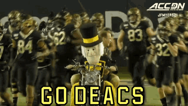 a group of football players are walking on a field with the words go deacs