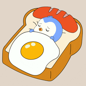 a penguin is sleeping on a piece of toast with an egg and sausage