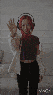 a woman wearing headphones stands in front of a wall with the word let 's on it