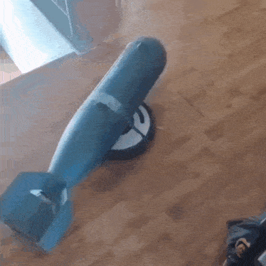 a toy bomb is sitting on a wood floor