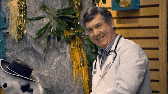 a man in a lab coat with a stethoscope around his neck