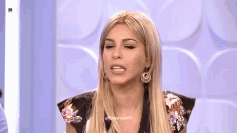 a woman with long blonde hair and earrings is making a funny face on a television show .