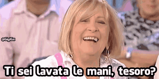 a woman is laughing with the words ti sei lavata le mani tesoro