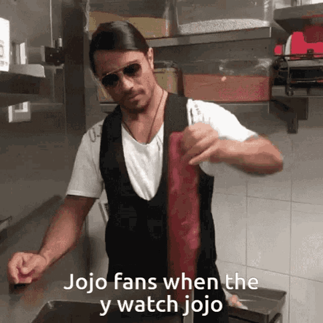 a man in a kitchen with the words jojo fans when the y watch jojo on the bottom