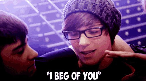 a boy wearing glasses and a beanie says i beg of you