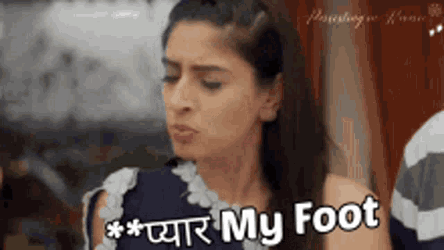 a woman is standing in front of a sign that says " my foot " .