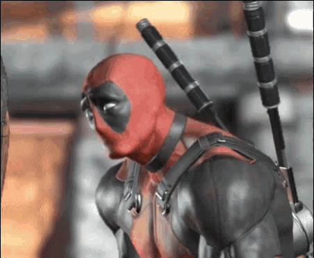 deadpool is wearing a red and black superhero costume and holding two swords .