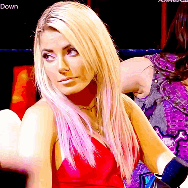 a blonde woman in a red dress with the word down on the bottom right