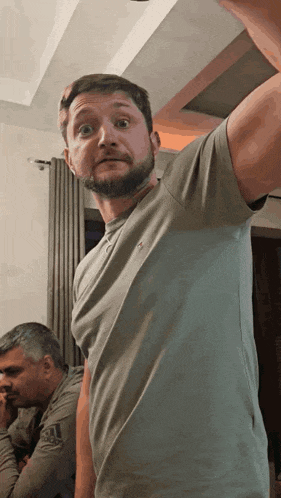 a man with a beard wearing a polo shirt