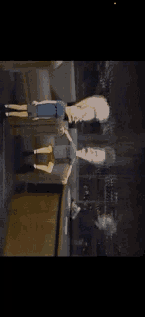 two cartoon characters standing next to each other in a dark room .