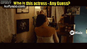 a woman is looking at herself in a mirror with the words who is this actress any guess