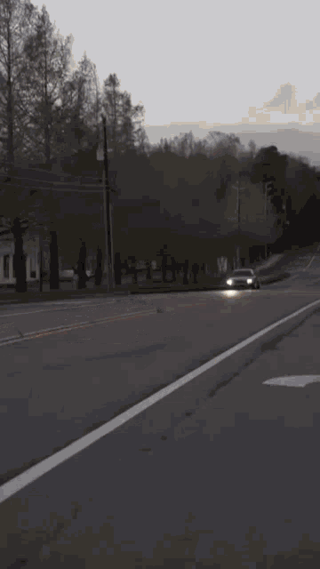 a car is driving down a road with a white arrow pointing to the right