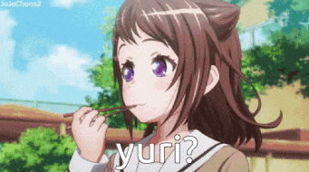 a girl with purple eyes is eating a lollipop and the word yuri is on the bottom