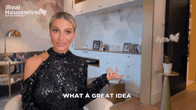 a woman in a black sequined top is sitting in a living room and says what a great idea
