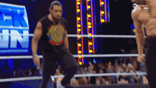 a man in a wrestling ring with a sign that says tn sports 1 on it