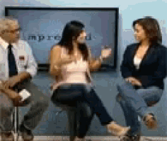 a man and two women are sitting in front of a screen that says improu