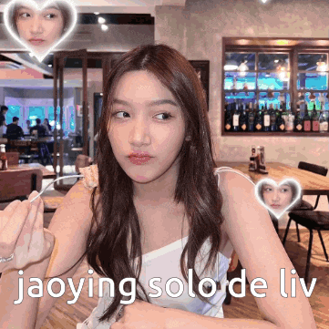 a woman is sitting at a table with the words jaoying solo de liv written on the bottom