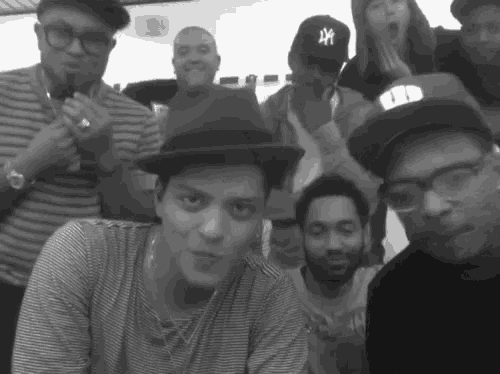 a group of people are posing for a picture and one of them has a ny hat on